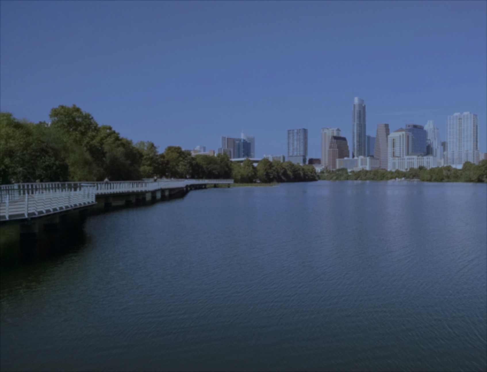 background image of Austin skyline and boardwalk along Town Lake.